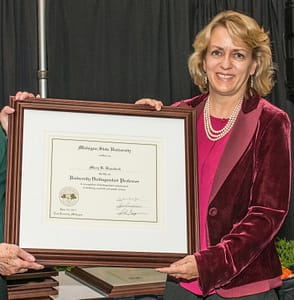 Mary Hausbeck Displaying DIstinguished Faculty Award